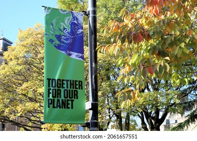Glasgow, Scotland - October 21 2021: UN Climate Change Conference COP26 Banner in a Glasgow street with the words Together for Our Planet, with a tree in leaf behind it.