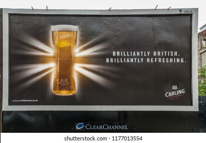 Glasgow, Scotland, UK - June 17, 2012: Closeup Of Large Black Billboard With Golden Glass Of Carling Beer Presented As Brilliantly And British Flag In Disguise.