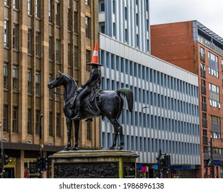 GLASGOW, UK - May , 2021: A view lookng up at the statue of the Duke of Wellington  in Glasgow on a summers day
