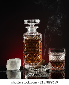 A Glass Of Alcohol With A Cigar In An Ashtray And A Decanter.