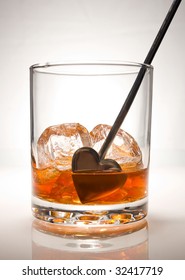 Glass with alcohol and heart shaped stirrer