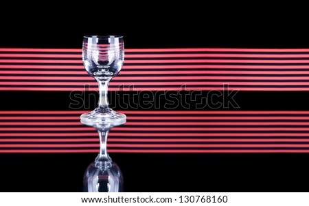Glass of alcohol on disco background, party atmosphere, copyspace