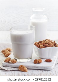 Glass Of Almond Milk  On White Wooden Background