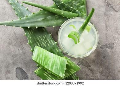 Glass Of Aloe Vera Juice On Grey Table