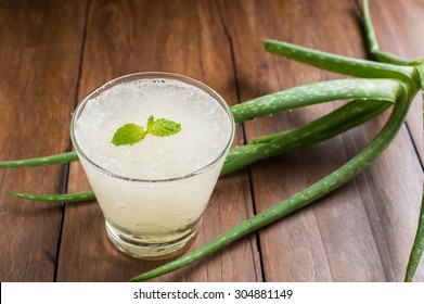 Glass Of Aloe Vera Juice On A Wooden Table