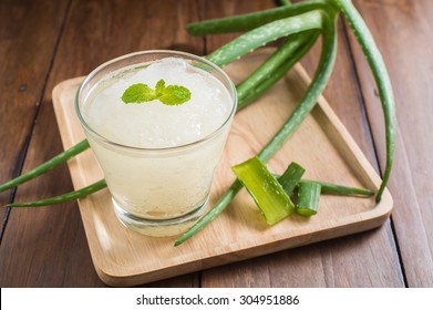 Glass Of Aloe Vera Juice On A Wooden Table