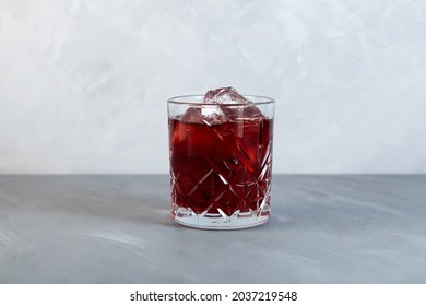 Glass Of Americano Alcohol Cocktail With Red Vermouth, Bitter, Soda Water And Ice Cubes.