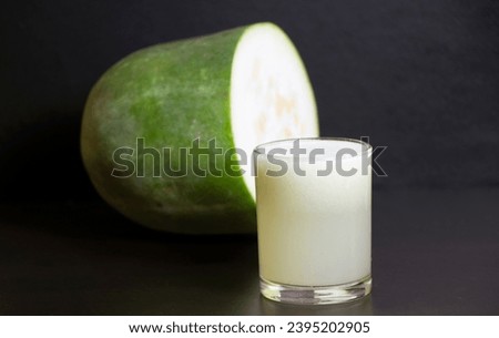 A glass of Ash gourd Juice in focus with Raw ash gourd in background. Foto stock © 
