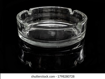 A Glass Ash Tray On The Black Background