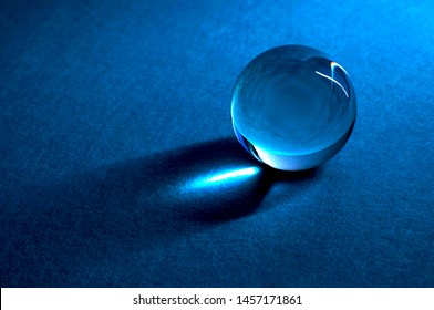 Glass ball. Crystal ball in abstract blue. Glass ball with shades and reflections