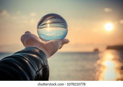 Glass ball in hand - Powered by Shutterstock