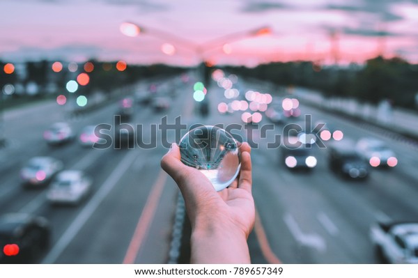 Glass ball in hand with\
travel.