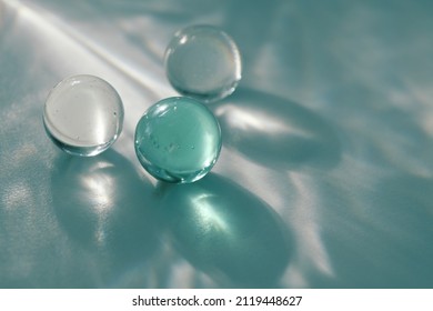 Glass ball on blurred soft focus gray grain texture rainbow refractionwall . Light and shadow smoke abstract copy space background.