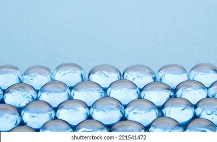 Glass Beads On Blue Background