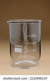 Glass Beaker 250 Ml. Useful in Science experiments, and Laboratory Glassware. Seamless Brown Color Background. - Shutterstock ID 2210900119