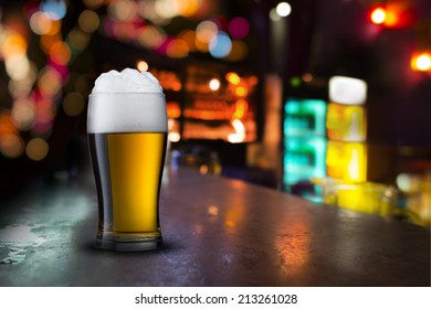 Glass Of Beer With Bar Scene In The Background