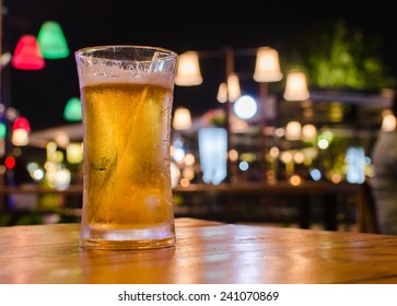 Glass Of Beer With Bar Scene In The Background