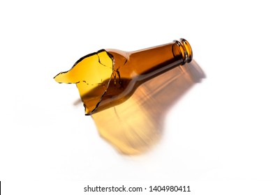 Glass beer bottle broken in half isolated on white background. Opaque glass bottle of brown color cracked. Improvised weapon.