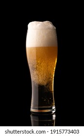 Glass Of Beer With Bubbles And Thick White Foam, Isolated On Black Background