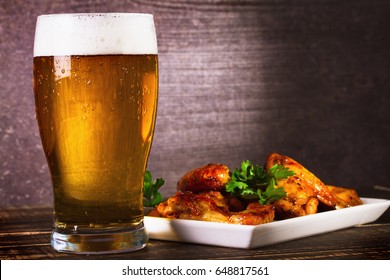 Glass Of Beer And Buffalo Chicken Wings. Beer Bites