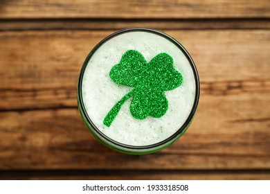 Glass of beer with clover leaf on wooden table, top view. St Patrick's Day celebration - Powered by Shutterstock