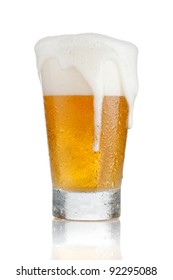 Glass Of Beer With Foam Coming Out