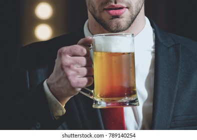 Glass Of Beer In Hand Of Sommelier Man With Beard In Formal Outfit Near Mirror With Lamps, Meeting And Relax, Bar And Restaurant, Tasting And Degustation