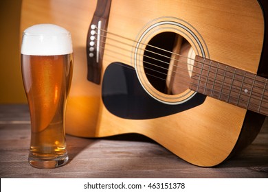 Glass Of Beer Near Acoustic Guitar.