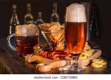 Glass Of Beer On Bar Counter, Charcuterie Plate Board, Meat, Boiled Pork, Smoked Meats, Prosciutto. Jugs, Mugs, Pints Of Beverage, Ale, Cider, Snack On Wooden Table In Pub, Bar In Vintage Brewery.