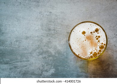Glass of beer on a concrete table