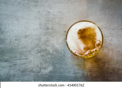 Glass of beer on a concrete table