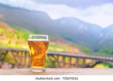 Glass of beer on the edge of the handrail