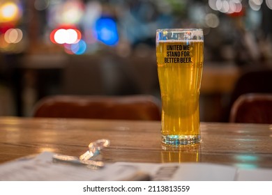 Glass Of Beer On A Table In A Pub, Blurred Background. Concept: Friday Night Out, Evening, Alcohol, Drinks, Bar, Menu, Restaurant