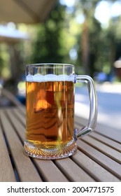 Glass Of Beer On Wooden Table Of Restaurant Veranda