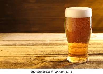 Glass of beer on wooden table, space for text - Powered by Shutterstock