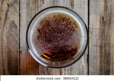 glass of beer shot top down on wooden rustic table