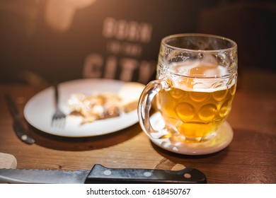 Glass Of Beer With Snack Food On A Plate In Prague Old Pub