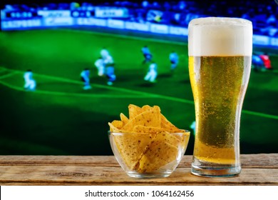 Glass Of Beer And Snack On A Football Game TV Background