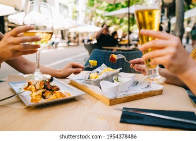 a glass of beer and wine on a table with utensils two girls have dinner together in a restaurant on the terrace in summer - Shutterstock ID 1954378486