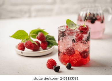 Glass of berry cocktail or drink soda with fresh berries on white background - Powered by Shutterstock