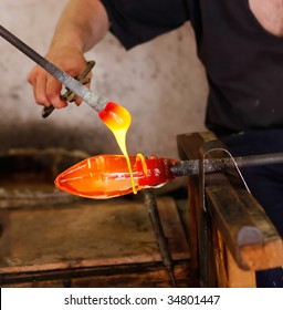 Glass blower forming a decorative vase. (Murano, Italy)