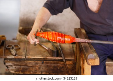 Glass blower forming a decorative vase. (Murano, Italy)