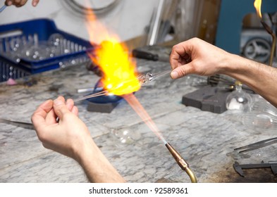 Glass blower forming a piece of decorative glass