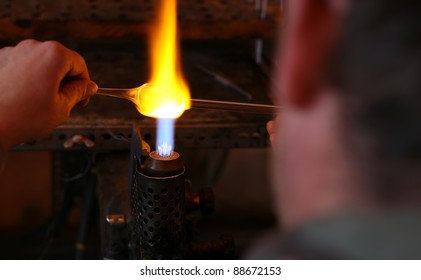 Glass blower.The making of.The master heats up the glass. - Powered by Shutterstock