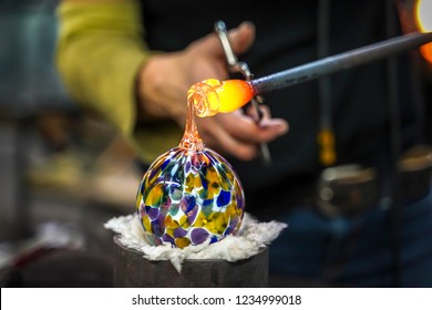 A Glass Blower Shaping Molten Glass into a Piece of Art - Powered by Shutterstock