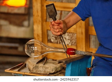 A Glass Blower Shaping Molten Glass into a Piece of Art - Powered by Shutterstock