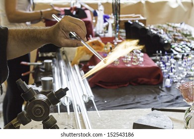 Glass blower working on crafts market, manufacture and workshop