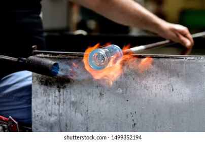 Glass Blowing Art And Flame.
Handmade Glassware Is Produced On High Fire.