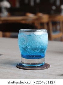 A glass of blue summer float. Blue raspberry syrop add with carbonated water and a scoop of vanilla ice cream 