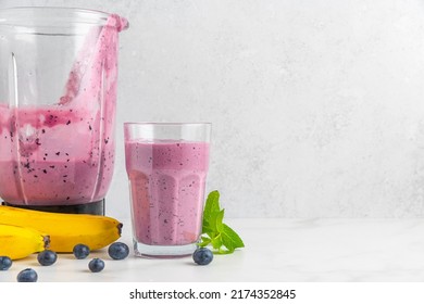 Glass Of Blueberry And Banana Smoothie With Fresh Juicy Fruits And Blender For Making Healthy Summer Drink. Cooking Concept